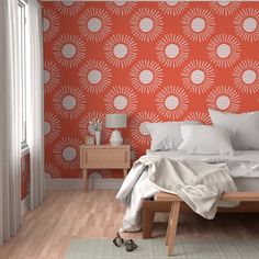 a bedroom with an orange and white wallpaper