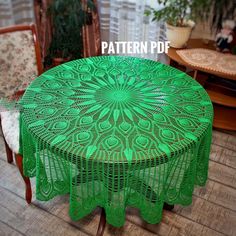 a green table with lacy doily on it