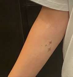 a woman's arm with three stars on the left side of her right arm