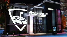 the topgol sign is lit up at night in front of a building with lights on it