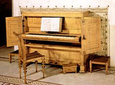 an old piano sitting in the corner of a room