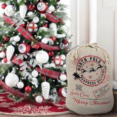 a christmas tree with ornaments and a bag next to it