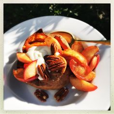 a white plate topped with fruit and nuts