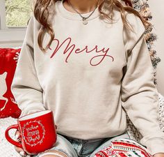 Introducing our Embroidered Merry Crewneck Sweatshirt, the perfect addition to your festive wardrobe! This Cute Minimalistic Soft Comfy Christmas Sweatshirt is designed to bring joy and comfort to your holiday season. Featuring intricate embroidery, our Merry Crewneck Sweatshirt showcases a stunning and stylish design, instantly elevating your Christmas outfit. The meticulous attention to detail ensures a high-quality finish that will impress everyone around you. But it’s not just about th Comfy Christmas, Christmas Shirts For Women, Merry Bright Christmas, Bright Christmas, Sweatshirt Christmas, Sweater Womens, Holiday Sweater