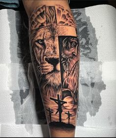 a man with a cross and lion tattoo on his arm