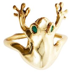 Rossella Ugolini 18k yellow gold and emeralds ring, handcrafted in Italy. This unique ring takes the form of a frog, meticulously designed and adorned with captivating emerald eyes. The frog, crafted in 18k yellow gold, elegantly wraps around the finger, with its front legs extended forward as if holding on. This 18k yellow gold and emeralds ring is a playful, comfortable, and unique unisex accessory that is sure to catch everyone's attention. The frog, in many cultures, symbolizes transformatio Frog Ring, Sapphire Eyes, Emerald Eyes, Unisex Earrings, Whimsical Jewelry, Modern Engagement Rings, Diamond Eyes, A Frog, Modern Ring