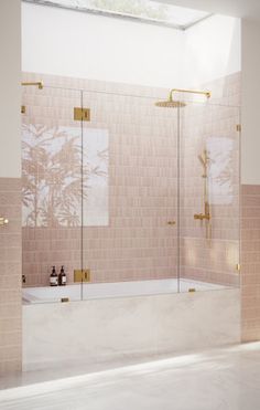 a bathroom with pink tiles and gold fixtures