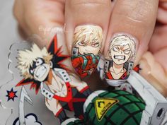 a person with some anime nail art on their nails and one is holding the other hand