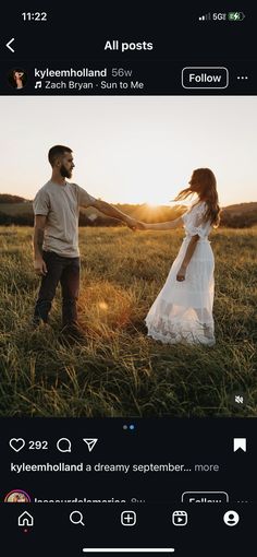 a man and woman holding hands in a field with the sun shining down on them