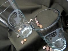 two glasses sitting on top of a black cloth