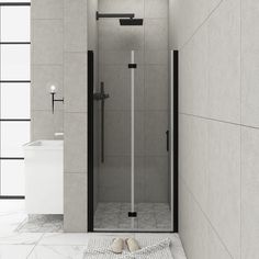 a bathroom with a shower stall, toilet and towel on the floor next to it