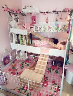 a doll house with pink walls and flooring in the room, including stairs leading up to an upper level bed