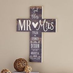 a wooden cross sitting on top of a table next to some baskets and yarn balls