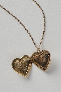 A super sweet gift or an accessory unique to you, this darling monogram necklace features a heart locket pendant with an initial engraving. **Features:** Dainty chain, heart locket pendant, hinge opening mechanism, monogram initial engraving, clasp closure **Why We | Monogram Necklace by Free People in Gold Picture Locket Necklace, Heart-shaped Vintage Charm Jewelry For Keepsake, Vintage Personalized Open Heart Jewelry, Vintage Open Heart Keepsake Jewelry, Vintage Open Heart Locket Necklace For Valentine's Day, Heart Charm Medallion Jewelry For Anniversary Gift, Vintage Double Heart Personalized Jewelry, Personalized Vintage Double Heart Jewelry, Engraved Heart-shaped Brass Jewelry