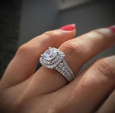 a woman's hand with a diamond ring on it