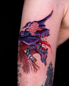 a woman's arm with a tattoo on it that has an image of a witch