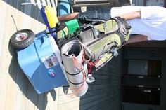 a man is sitting on a deck with his back pack and camping gear in front of him