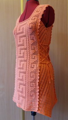 an orange crocheted top on a mannequin