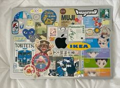 an apple laptop covered in many stickers