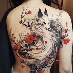 the back of a woman's body with an artistic tattoo design on her shoulder