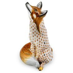 a figurine of a fox sitting on the ground