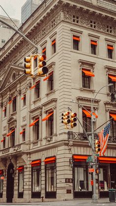 an old building with orange lights on the corner