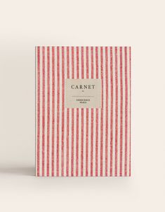 a red and white striped book with a label on the cover that says carnet