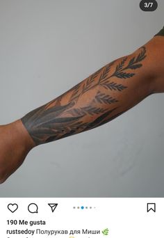 a man's arm with tattoos on it and an arrow in the middle of his arm