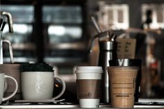 coffee cups are lined up on the counter