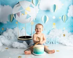 a baby sitting in front of a cake