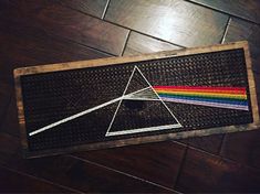 a dark side of the moon sign on a wooden floor