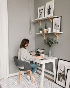 a woman sitting at a desk working on her laptop