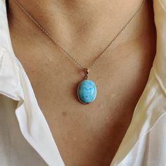 ITEM DESCRIPTION: >>The pendant is made from Solid 14K Yellow Gold. Gemstone used is absolutely natural and ethically sourced. >>Natural Larimar in cabochon cut and oval shape with bezel setting is studded on it with utmost precision. >>This is a minimalist design and is absolutely hassle-free and everyday jewelry. Gem: Larimar Gem size: 12x16 mm Gem weight: 9.54 carats Gold purity: 14K (58.33% approx.) Gold weight: 0.51 grams Gross weight: 2.42 grams The Gold purity is guaranteed and it comes w Round Larimar Jewelry Gift, Handmade Larimar Round Necklace, Oval Blue Larimar Jewelry, Larimar Gemstone Pendant Necklace, Larimar Pendant, Gold Pendant Necklace, March Birth Stone, Everyday Jewelry, Gold Pendant