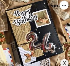 a happy birthday card with the number twenty four on it, surrounded by envelopes and papers