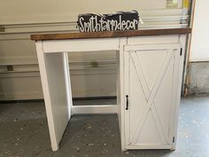 a white desk with a sign on top