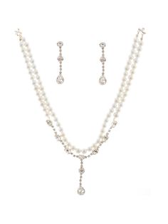 a white necklace and earring set with pearls on the bottom, along with a pair of earrings