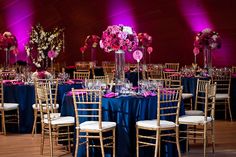 the tables are set up with purple and pink flowers