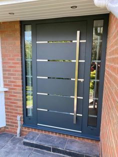 a modern steel door on a brick building