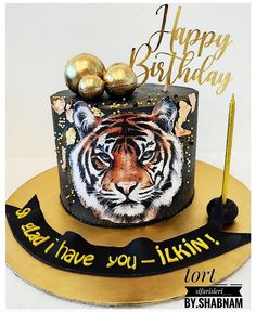 a birthday cake with an image of a tiger on the top and gold decorations around it