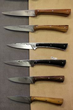 five knives are lined up on a table with the names of different types and colors