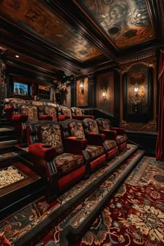 an ornately decorated home theater with red velvet seats