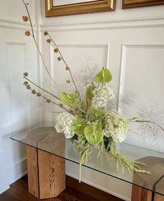 a glass table with some flowers on it