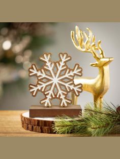 a gold reindeer figurine with snowflakes on it's antlers