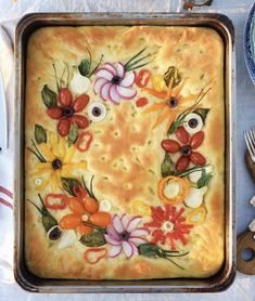 a pan filled with food on top of a table next to plates and utensils