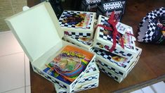 several boxes are stacked on top of each other with candy in them and ribbons tied around the edges