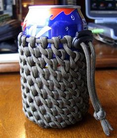 a can wrapped in rope sitting on top of a wooden table