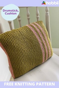 a knitted pillow sitting on top of a white chair