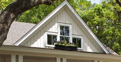 a white house with flowers in the window