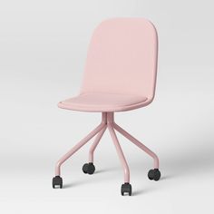 a pink chair sitting on top of a white floor