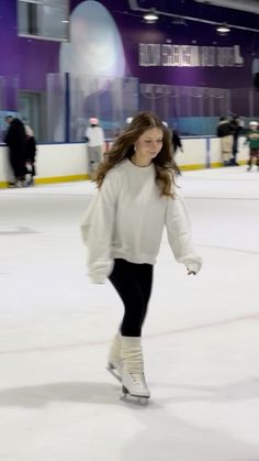 a young woman skating on an ice rink